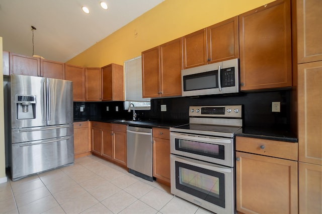 kitchen featuring sink, decorative backsplash, appliances with stainless steel finishes, and light tile patterned flooring