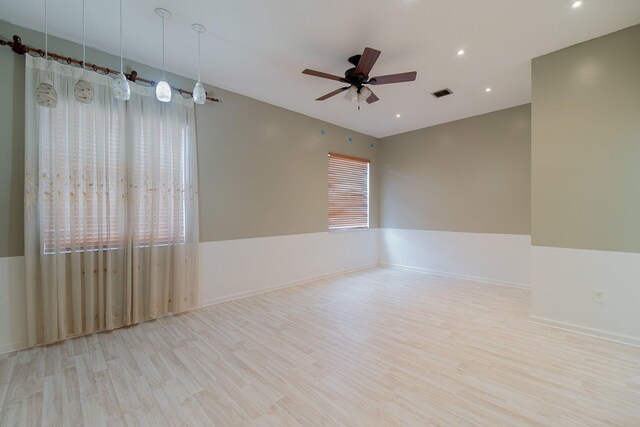 empty room with light wood-type flooring and ceiling fan