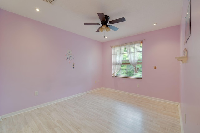 spare room featuring light hardwood / wood-style flooring and ceiling fan