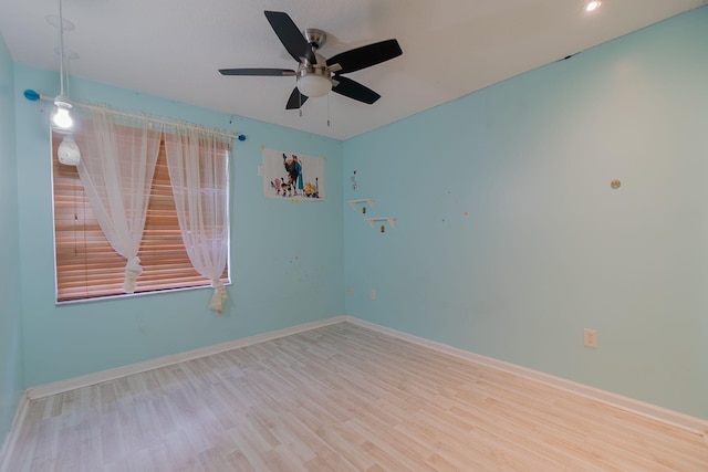 empty room featuring wood-type flooring and ceiling fan