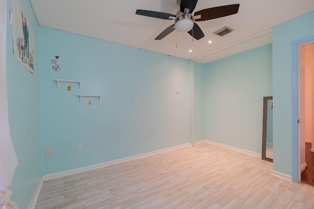 spare room with light hardwood / wood-style floors and ceiling fan