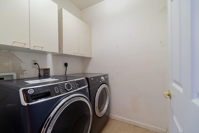 clothes washing area featuring cabinets, light tile patterned flooring, and independent washer and dryer