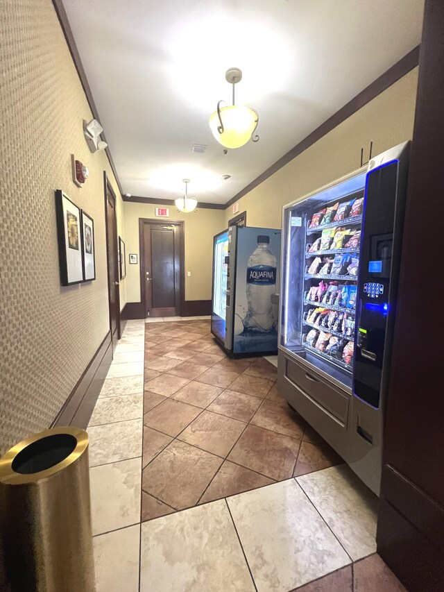 interior space with tile patterned flooring and ornamental molding