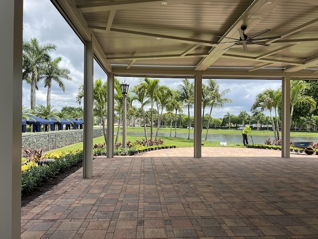 view of patio / terrace featuring a water view and ceiling fan