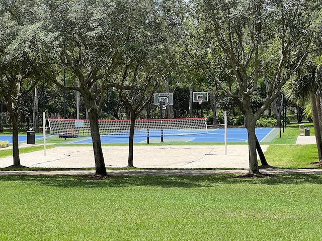 view of sport court with a yard