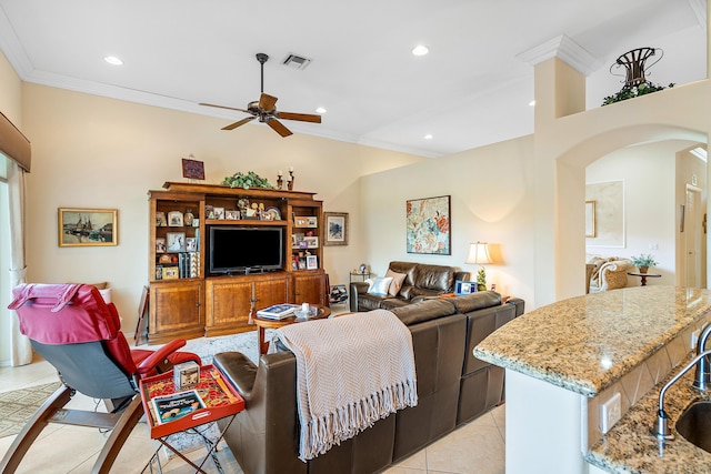 living room featuring light tile patterned floors, ceiling fan, ornamental molding, and sink