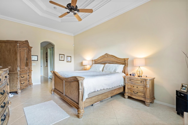 tiled bedroom featuring a tray ceiling, ceiling fan, and ornamental molding