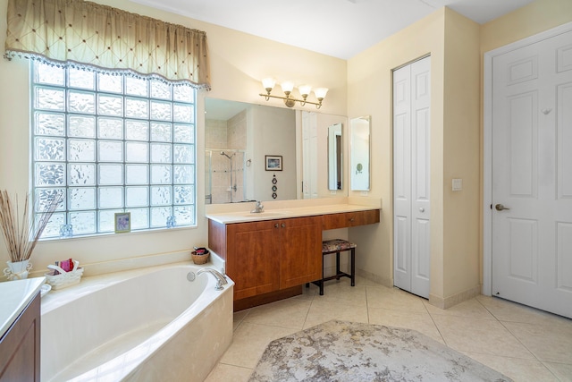 bathroom featuring vanity, separate shower and tub, a wealth of natural light, and tile patterned floors