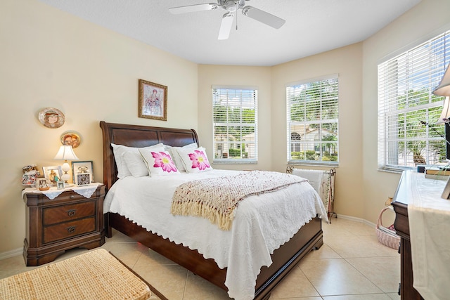 bedroom featuring ceiling fan, a textured ceiling, and light tile patterned floors