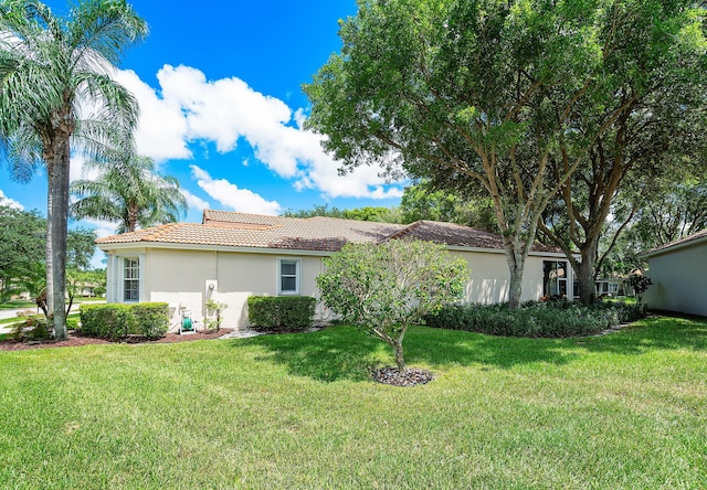 view of property exterior with a lawn