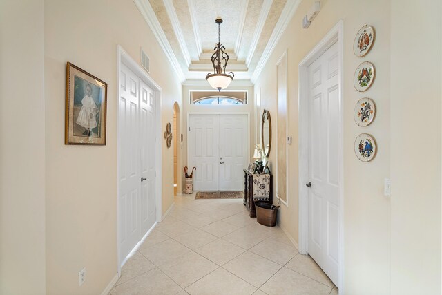 dining space with light tile patterned floors, an inviting chandelier, and ornamental molding