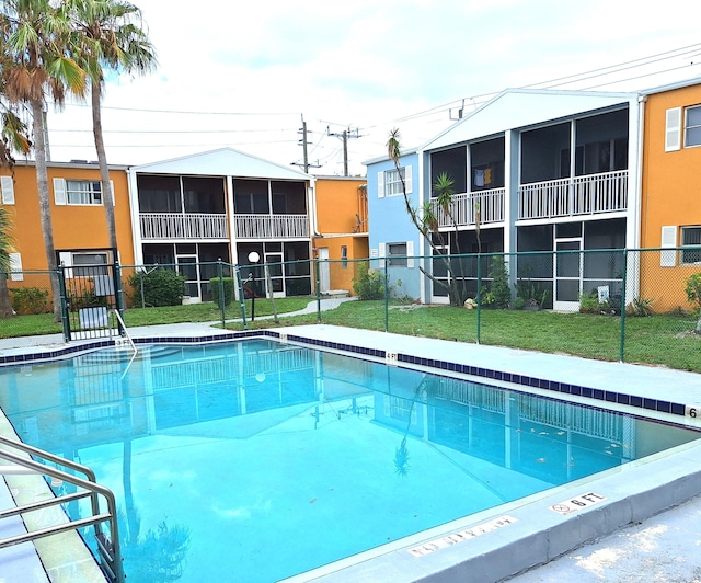 view of swimming pool with a lawn