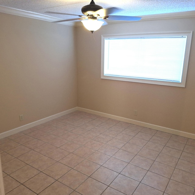 tiled spare room with ceiling fan and crown molding