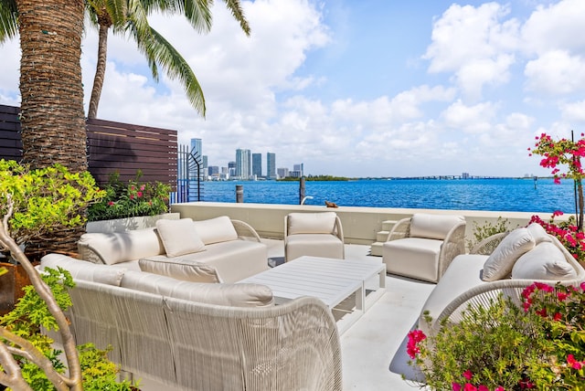 view of terrace featuring an outdoor living space and a water view