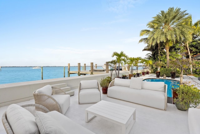 view of patio with an outdoor living space and a water view