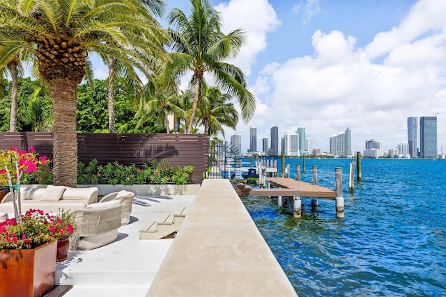 dock area with an outdoor hangout area and a water view