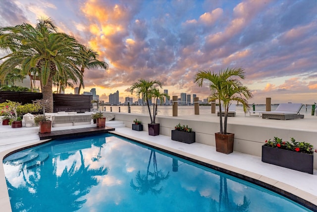 view of pool at dusk