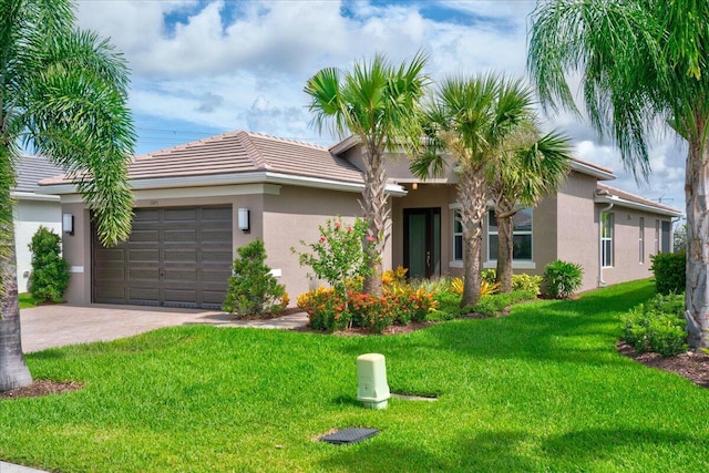 view of front of house with a front yard and a garage