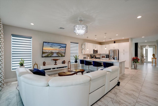 living room with an inviting chandelier