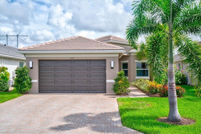 view of front of house with a front yard and a garage