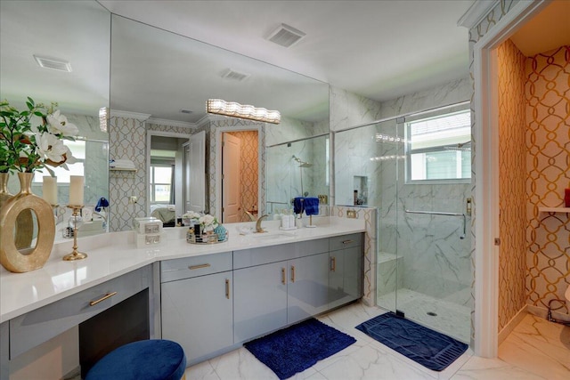 bathroom with vanity, plenty of natural light, and a shower with door