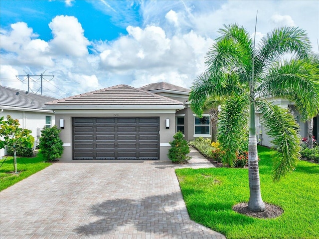 view of front of property featuring a front lawn and a garage