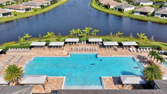 view of pool with a patio area and a water view