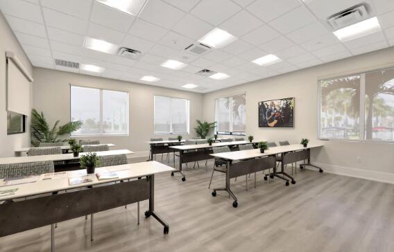 office with light hardwood / wood-style floors and a drop ceiling