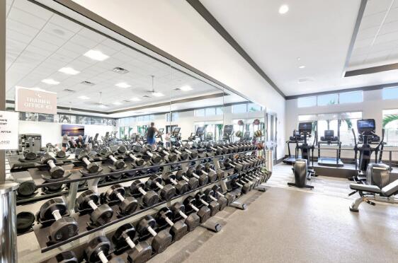 exercise room with a drop ceiling and a raised ceiling