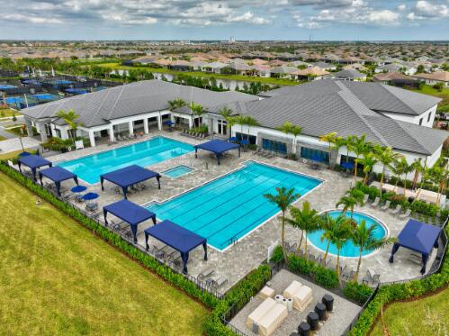 view of pool with a patio and a lawn