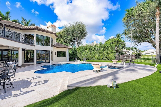 view of swimming pool with a lawn, a patio area, fence, and a fenced in pool