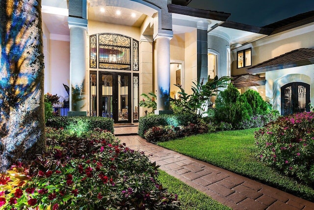 view of exterior entry with stucco siding and french doors