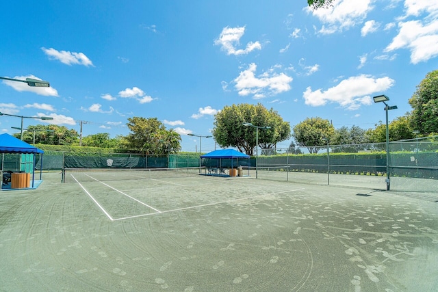 view of tennis court with fence