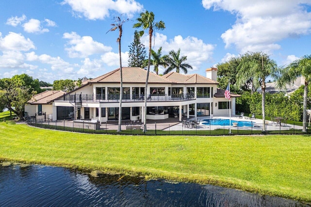 back of property featuring a patio, fence, a yard, a fenced in pool, and a chimney