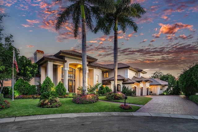 mediterranean / spanish home featuring a yard