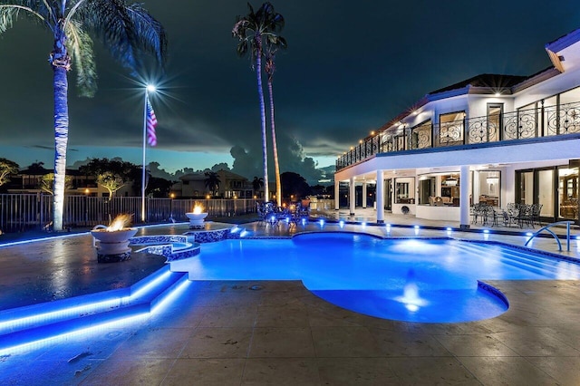 pool at twilight with a patio