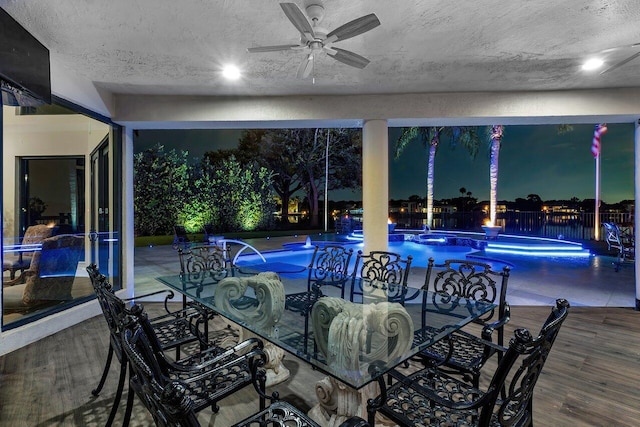 view of patio / terrace featuring ceiling fan, outdoor dining area, fence, and a fenced in pool