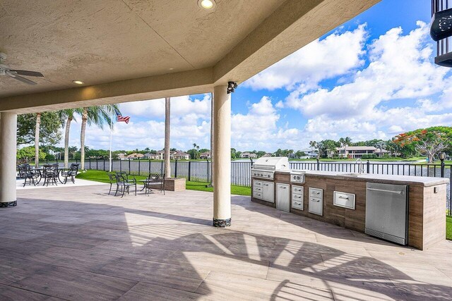 view of patio / terrace with area for grilling, a grill, and ceiling fan