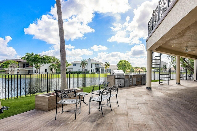 view of patio / terrace featuring an outdoor kitchen, a residential view, grilling area, stairs, and fence