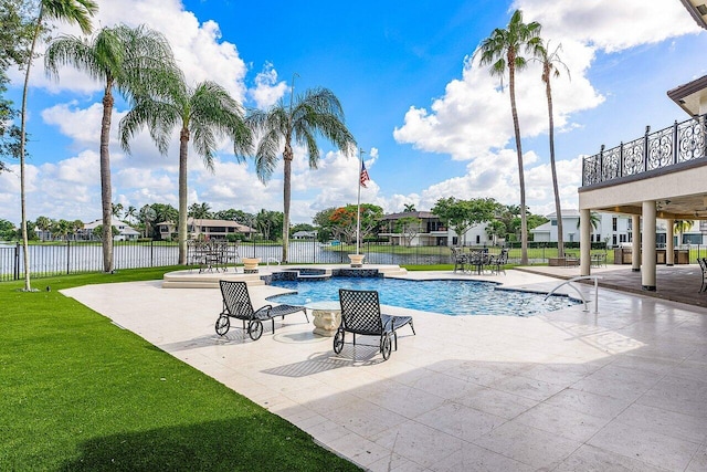 view of pool featuring a yard, a patio area, fence, and a pool with connected hot tub