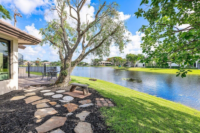 view of yard with a water view and a patio