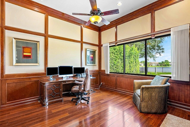 office featuring a wainscoted wall, ceiling fan, wood finished floors, and a decorative wall