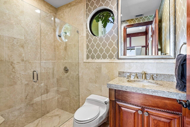 bathroom featuring tile walls, toilet, vanity, and an enclosed shower