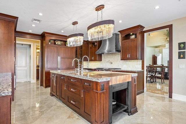 kitchen featuring marble finish floor, wall chimney exhaust hood, open shelves, visible vents, and baseboards