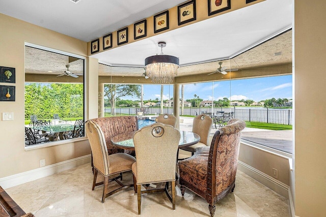 sunroom / solarium with a chandelier