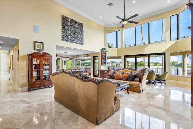 living room featuring marble finish floor, a wealth of natural light, and visible vents