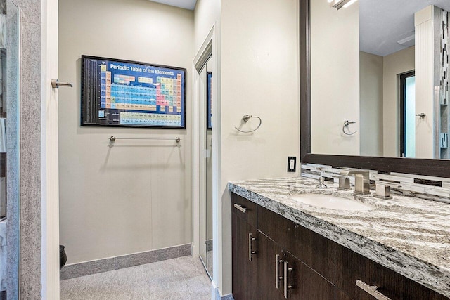 bathroom featuring baseboards and vanity