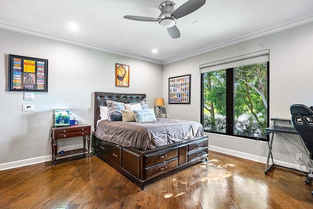 bedroom featuring baseboards, wood finished floors, and crown molding