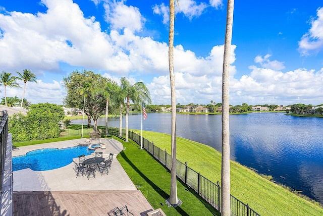 view of swimming pool with a water view, a patio area, fence, and a yard