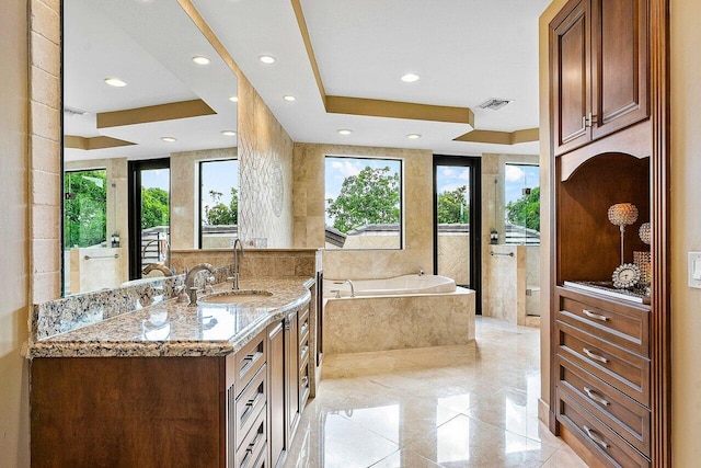 full bath featuring vanity, visible vents, marble finish floor, a bath, and a raised ceiling